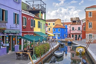 Colourful restaurants and brightly coloured houses along canal at Burano