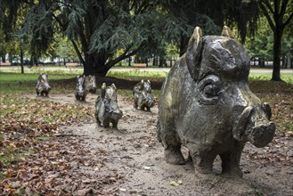 Sculpture group by Alex Garcia of bronze wild boars in the city park Roger Salengro at Nevers