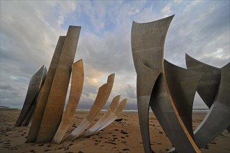 The WW2 American D-Day landing Omaha Beach monument Les Braves on the beach at Saint-Laurent-sur-Mer at sunset