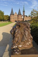 Lion statue in front of the Holstentor Holstein Gate in the Hanseatic town Luebeck