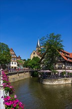 View from the Agnes Bridge over the Rossneckar Canal onto beer garden restaurants in a half-timbered ambience