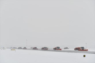 Road sweepers and snow ploughs clear snow on the taxiways and Runway North