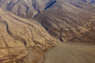 Aerial view of deep gullies carved by water erosion and U-shaped valley created by retreating glacier at Spitsbergen