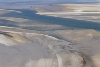 Aerial view of estuary on tidal mud flat at the Schleswig-Holstein Wadden Sea National Park