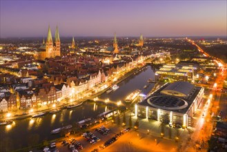 Aerial view over the river Trave and old town and churches of the Hanseatic City of Luebeck at sunset