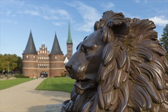 Lion statue in front of the Holstentor Holstein Gate in the Hanseatic town Luebeck