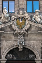 Coat of arms and sculptures on the upper entrance portal of the historic Wolf Town Hall