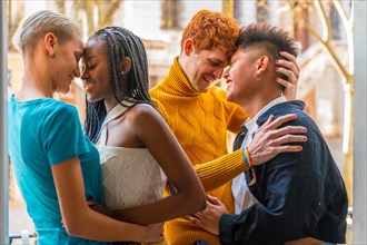 Portrait of couples of gay boys and lesbian girls embraced giving each other a kiss, lgtb concept