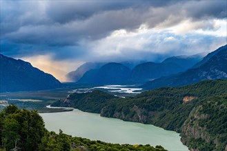 Rays of sunshine break through the rain clouds over the river valley of the Rio Ibanez, Cerro Castillo National Park, Aysen, Patagonia, Chile, South America