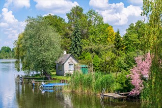 View from the Wublitz Bridge of a garden with a summer house and the Wublitz, a tributary of the Havel, Golm, Potsdam, Brandenburg, Germany, Europe