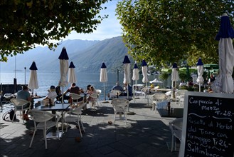 Restaurant on the lake promenade with a view of Lake Maggiore, Ascona, Canton Ticino, Switzerland, Europe