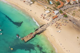 Pier and boats on turquoise water in city of Santa Maria, island of Sal, Cape Verde, Africa