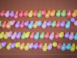 Balloon shooting game with balloons tied on a string