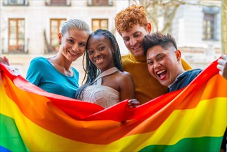 Lgtb couples of lesbian gay boys and girls in a portrait with rainbow flag