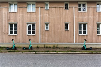 Three e-scooters parked in front of a residential building, Old Town Neristan, Kokkola, Central Ostrobothnia, Finland, Europe