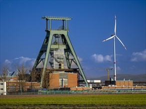 Former winding tower of Konrad shaft, wind turbine. The disused iron ore mine is being converted into a repository for low- and intermediate-level radioactive waste. Salzgitter, Lower Saxony, Germany,...