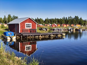 Red boathouses in Svedjehamn fishing harbour, idyll on the Baltic coast, Bjoerkoeby, Korsholm, Mustasaari, Kvarken Archipelago Nature Reserve, UNESCO World Heritage Site, Ostrobothnia, Finland, Europe