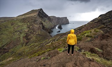 Hiker, coastal landscape, cliffs and sea, rugged coast with rock formations, Cape Ponta de Sao Lourenco, Madeira, Portugal, Europe