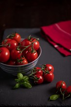 Red tomatoes in bowl on slate, fitness, cooking, vegetarian, vegan, vitamins, cultivation, healthy, close up, several, kitchen towel, Bailikum, Italian cuisine