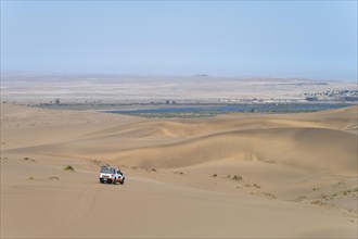 Off-road vehicle in sand dunes above the Orange River, also Oranjemund, Sperrgebiet National Park, also Tsau ÇKhaeb National Park, Namibia, Africa