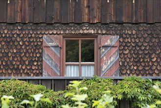 Wooden shingle facade with window and ornate shutters, Allgaeu, Bavaria, Germany, Europe