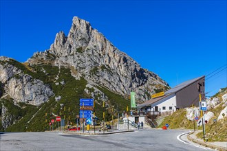 Signpost at Falzarego Pass, behind the peak of Sas de Stria, Hexenstein, Hexenfels, Dolomites, South Tyrol, Italy, Europe