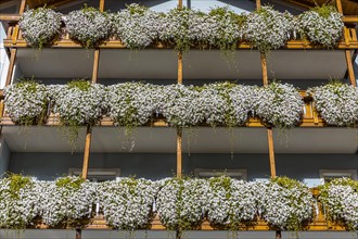 Balconies decorated with flowers in the centre of Ortisei, Val Gardena, Dolomites, South Tyrol, Italy, Europe