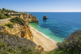 Beautiful cliffs and rock formations by the Atlantic Ocean at Marinha Beach in Algarve, Portugal, Europe