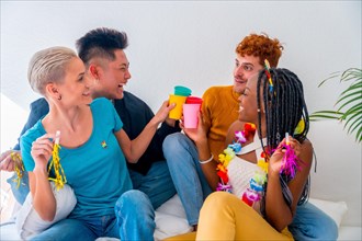 Lgtb couples of gay boys and girls lesbian in a portrait on a sofa at a house party, birthday party, toasting with glasses