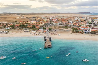 Pier and boats on turquoise water in city of Santa Maria, island of Sal, Cape Verde, Africa