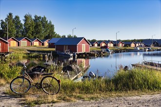 Red boathouses in Svedjehamn fishing harbour, Bjoerkoeby, Korsholm, Mustasaari, Kvarken Archipelago Nature Reserve, UNESCO World Heritage Site, Ostrobothnia, Finland, Europe