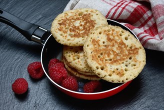 Blini, mini pancakes in pans with fruit, blini