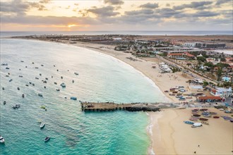 Pier and boats on turquoise water in city of Santa Maria, island of Sal, Cape Verde, Africa