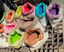 Sacks with paint pigment in different colors for sale
