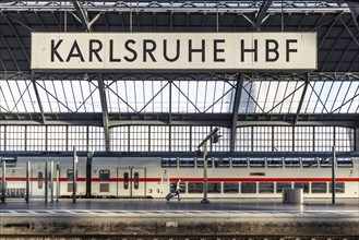 Main station with station sign, platform and InterCityExpress ICE of Deutsche Bahn, Karlsruhe, Baden-Wuerttemberg, Germany, Europe