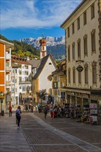 Pedestrian zone in the tourist town of Sankt Ulrich, Antonius Chapel in the back, Val Gardena, Dolomites, South Tyrol, Italy, Europe
