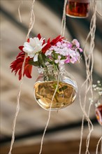 Herbal tea bottle with flowers hanging on string