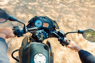 View of Hands of a motorcyclist on the handlebars. View of the hands on the handlebars of a motorcycle, Hands of man on the motorcycle handlebars