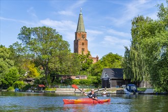 Paddler in a kayak in front of the Cathedral of St. Peter and Paul, Cathedral Island, Brandenburg an der Havel, Brandenburg, Germany, Europe