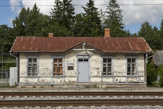 Railway tracks and weathered wooden house at the historic railway station in the village of Klooga, Harju County, Estonia, Europe