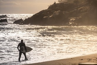 Silhouette of a surfer on the Costa Brava in the province of Gerona in Catalonia Spain