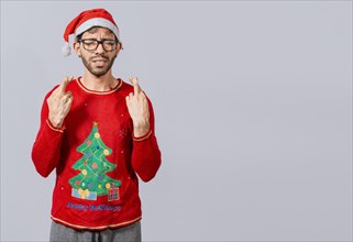 Guy with christmas hat making a wish on isolated background, Hopeful man in christmas clothes making a wish, Handsome man in christmas hat making a wish on white background