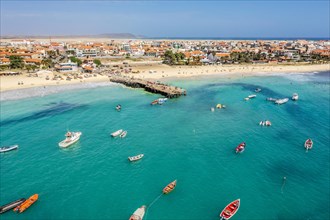 Pier and boats on turquoise water in city of Santa Maria, island of Sal, Cape Verde, Africa