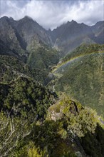 Rainbow in front of mountains, Miradouro dos Balcoes, Ribeira da Metade mountain valley and the central mountains, Madeira, Portugal, Europe