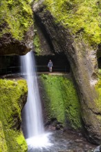 Hiker at Levada do Moinho, Waterfall in a gorge, Ponta do Sol, Madeira, Portugal, Europe