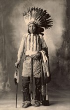 Chief with feather headdress from the Arapahoe tribe, after a picture by F.A.Rinehart, 1899, Historic, digitally restored reproduction of an original from the period