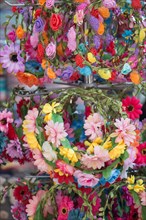 Colorful crowns for sale made of fake flowers