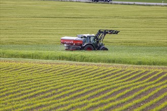 Farmer fertilising his fields with the tractor, Grabenstetten, Baden-Wuerttemberg, Germany, Europe