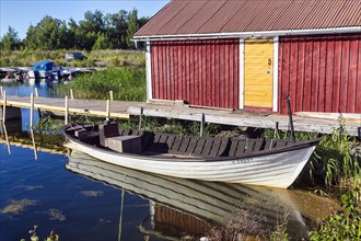 Red boathouse in Svedjehamn fishing harbour, Bjoerkoeby, Korsholm, Mustasaari, Kvarken Archipelago Nature Reserve, UNESCO World Heritage Site, Ostrobothnia, Finland, Europe