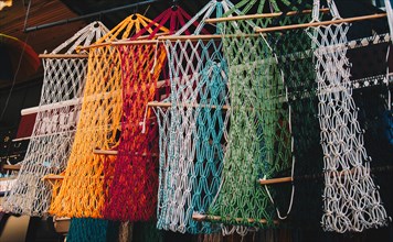 Empty mesh bags of various color at a market place